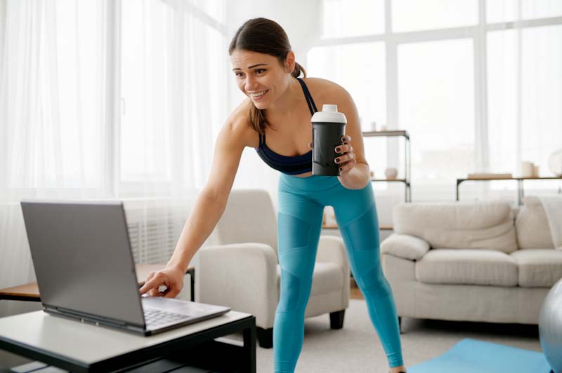 An online fitness coach checks out her marketing online in this file photo. If you want to learn about online fitness coaching and personal training, read more at EliteTrainr.com.