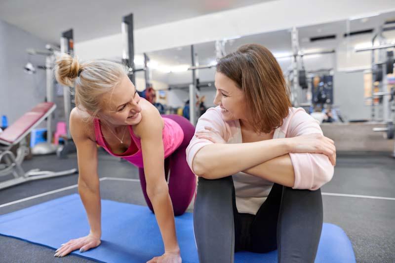 A fitness instructor chats with a client in the gym in this file photo. Learn about fitness instructor requirements at EliteTrainr.com.
