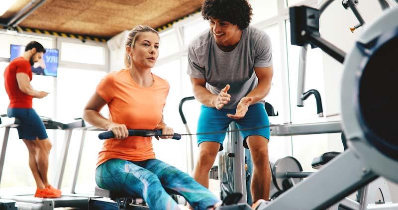 A new personal trainer works with a female client. If you want to learn How to Choose the Perfect Personal Training Niche, read this article by Chris from Elite Trainr.