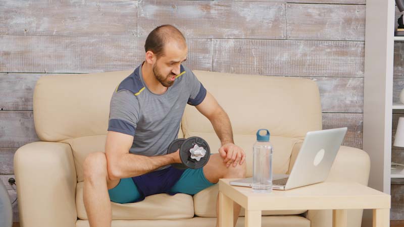  A personal trainer works with a client via a video call on their laptop. Using technology and software like EliteTrainr is a great way to display your professionalism.