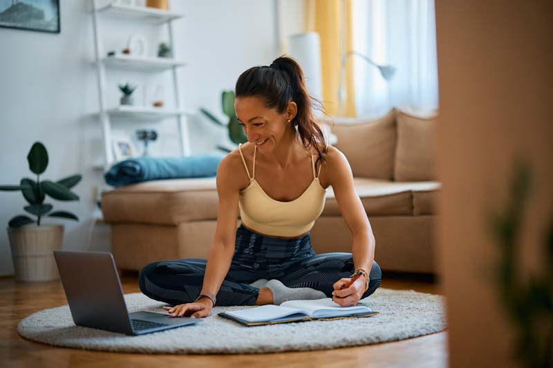 A personal trainer works on her business plan at home.