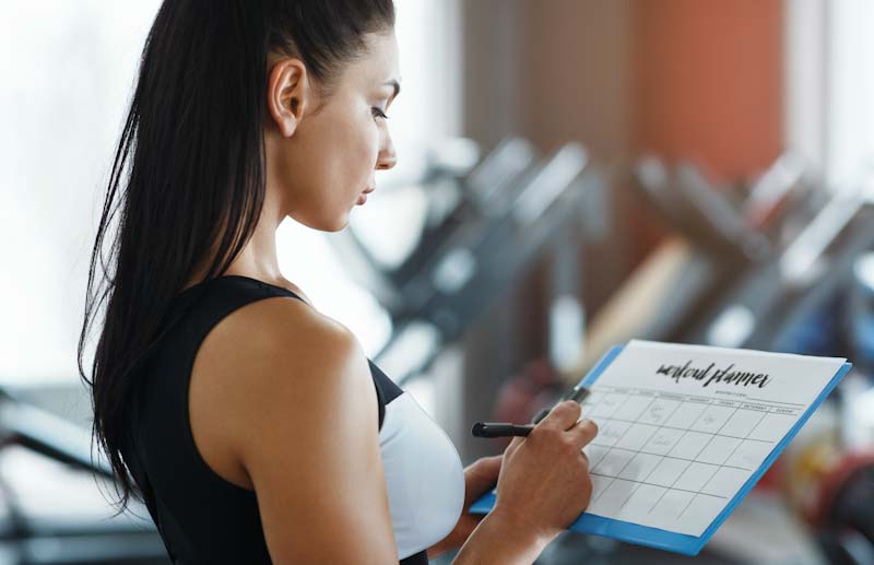 A personal trainer works on her schedule to fulfill goals set in her business plan. Learn more at EliteTrainr.com.