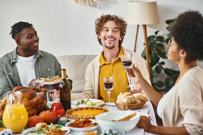 Family and friends indulge in a holiday feast. Learn how to manage your fitness clients through the holidays so they don't overindulge. Learn more at EliteTrainr.com.