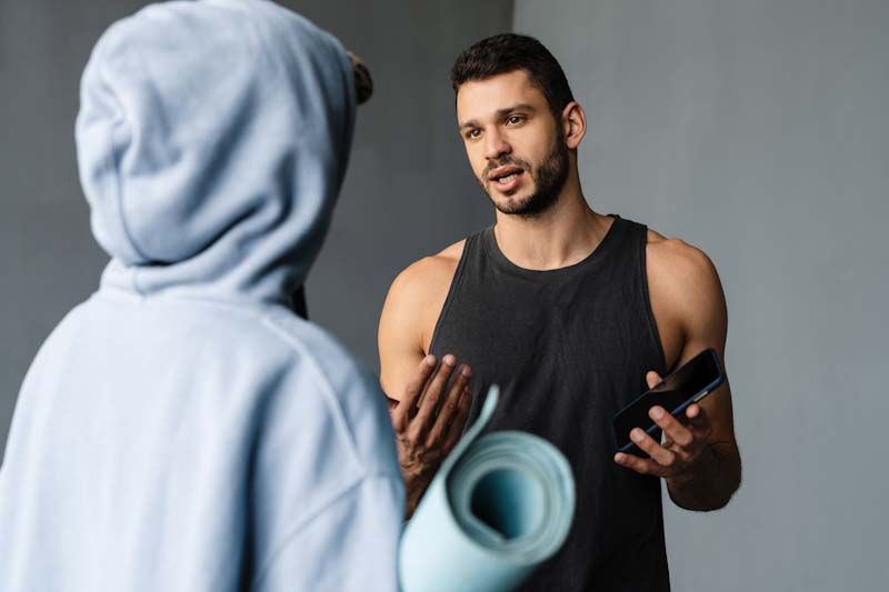 A new personal trainer explains their rates to a potential client.
