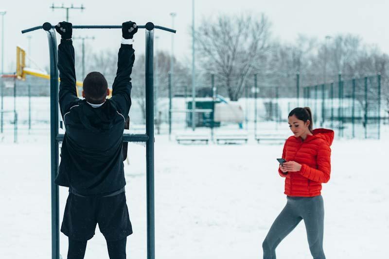 A couple work on their fitness with the guidance of their personal trainer using the Elite Trainr app. Learn more at EliteTrainr.com.
