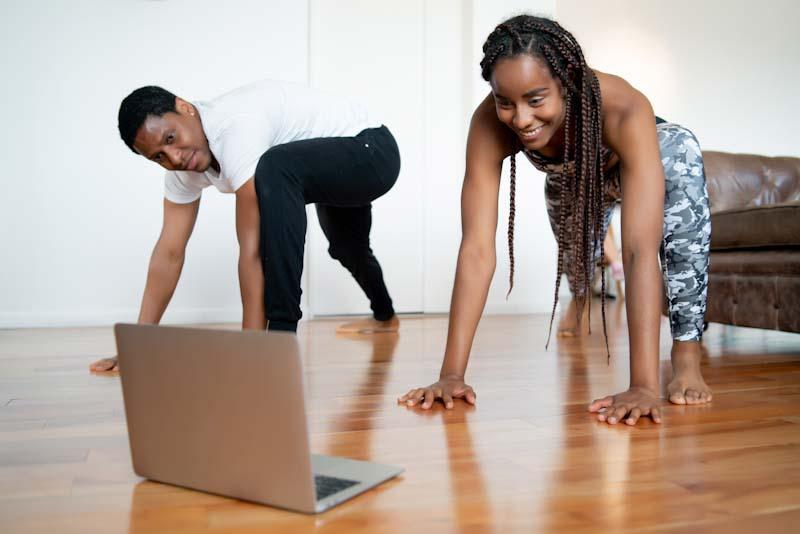 A couple joins their personal trainer online for virtual fitness training. Learn how you can manage your fitness clients online with EliteTrainr.com.